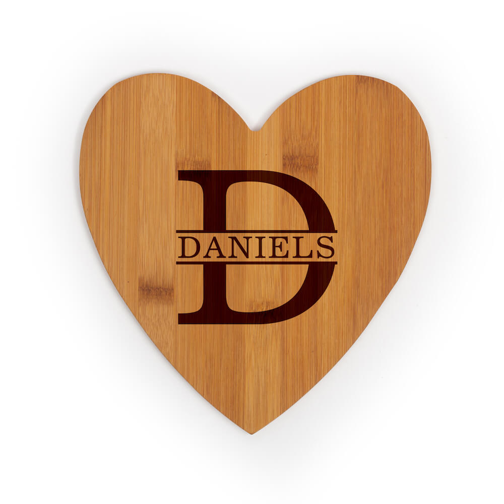 Heart shaped cutting board engraved with monogram of D and Daniels