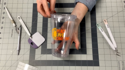 Clear tumbler customization project shown with the tools used